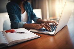 Woman Typing on Notebook Keyboard